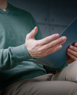 Young professional with clipboard at a psychological session in the office